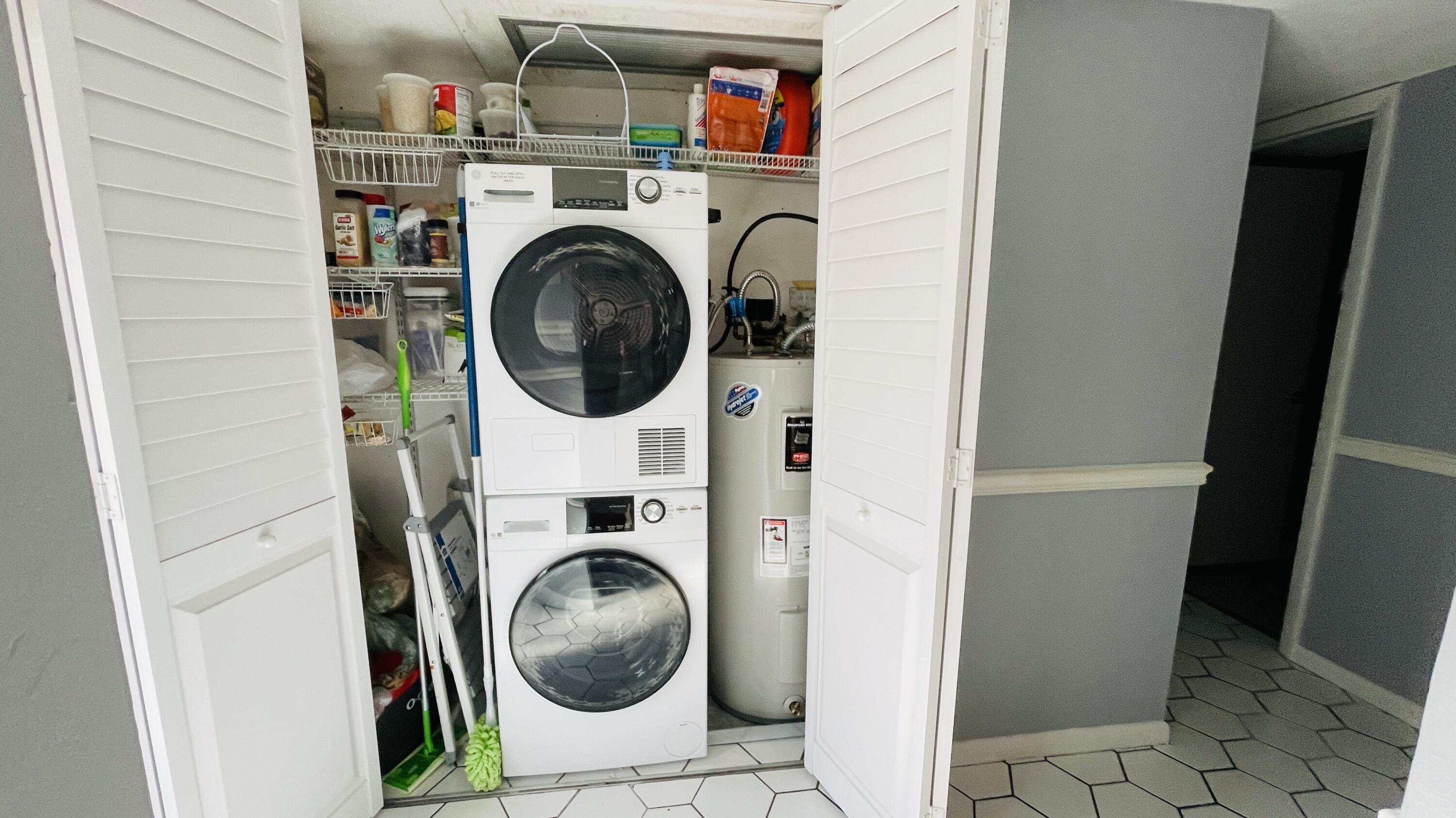 11 Golfs Edge, Unit E West Palm Beach, FL 33417 - Photo 7 of 14 a utility room with dryer and washer