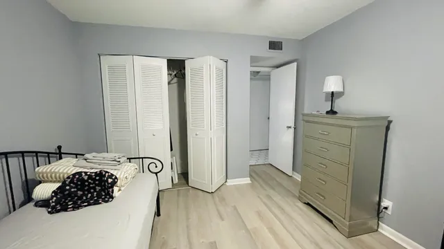 a bedroom with a bed and a dresser