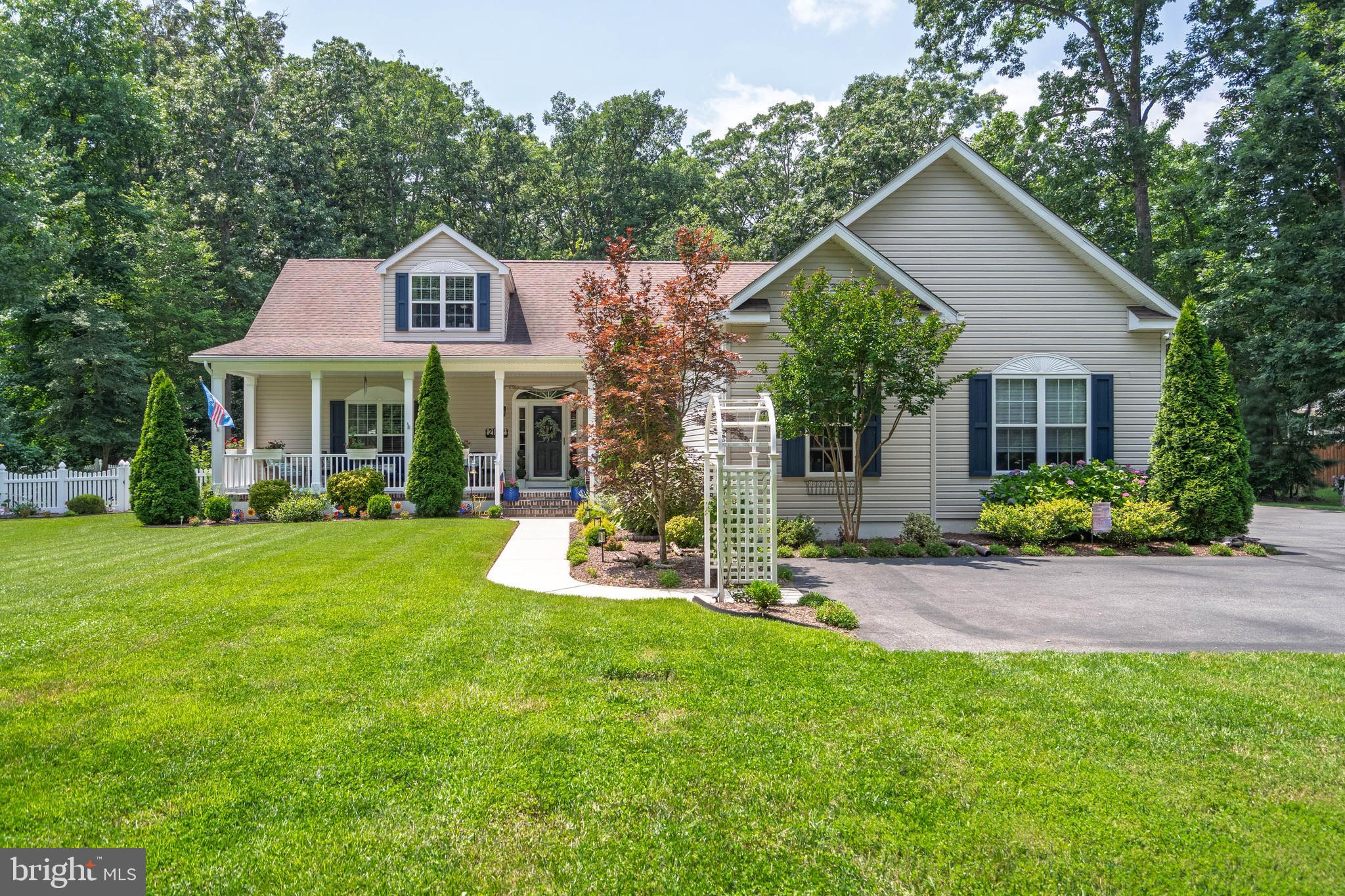 21062 Cool Spring Road Milton, DE 19968 - Photo 2 of 44 a front view of a house with a yard and porch