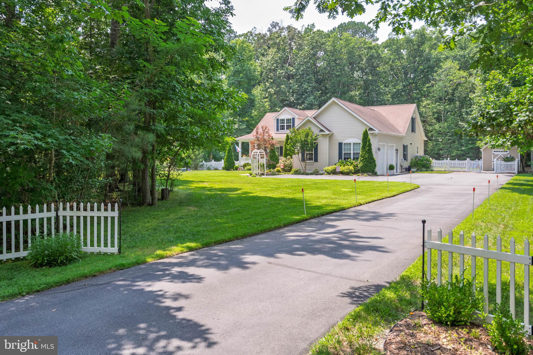 21062 Cool Spring Road Milton, DE 19968 - Photo 3 of 44 a view of a house with a yard and large trees