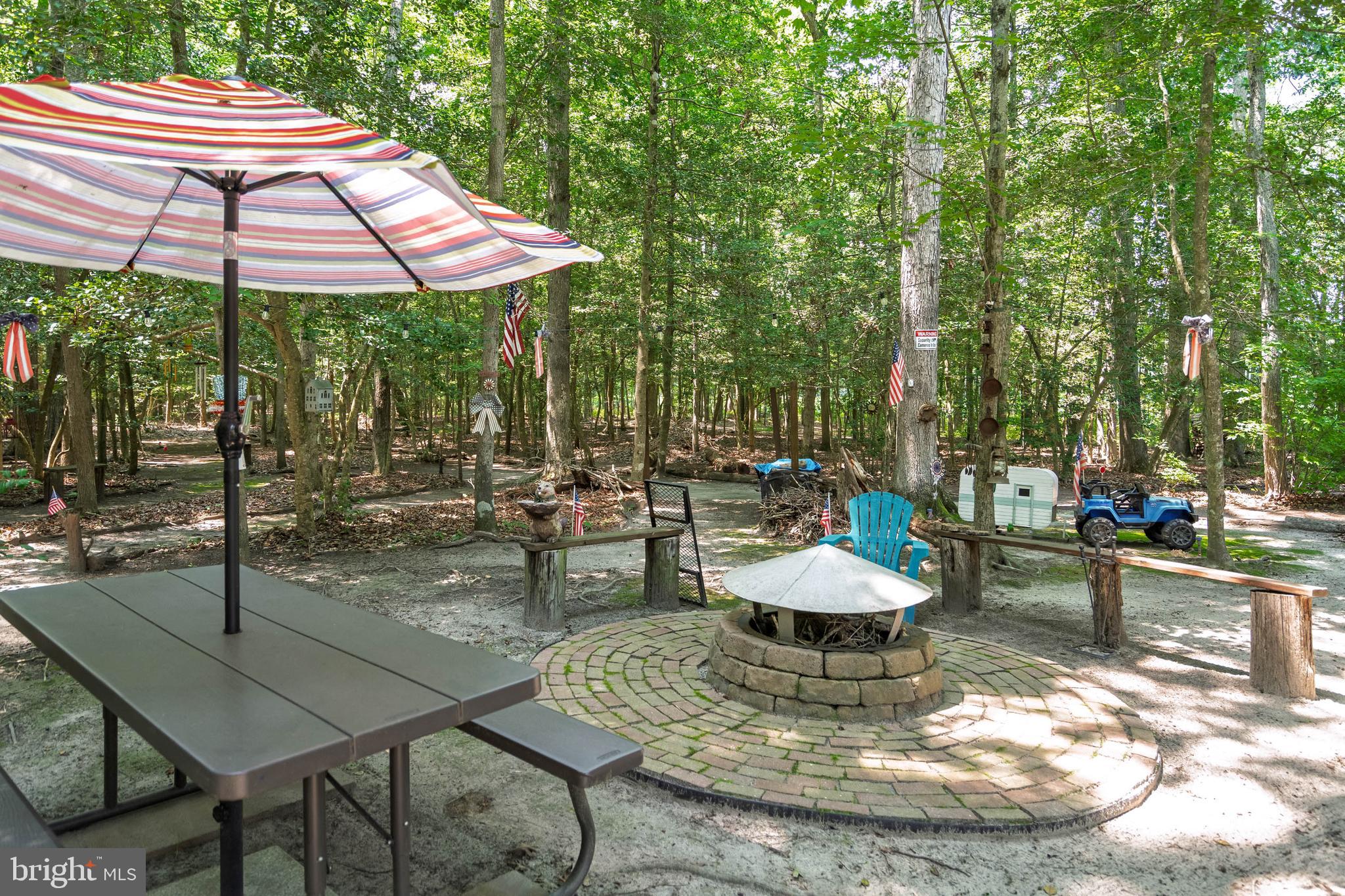 21062 Cool Spring Road Milton, DE 19968 - Photo 36 of 44 a view of a patio with a table and chairs under an umbrella