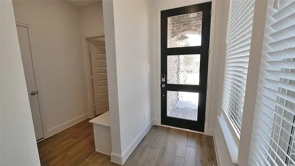 a view of front door with wooden floor