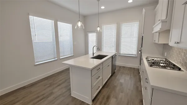 a kitchen with a sink stove and cabinets