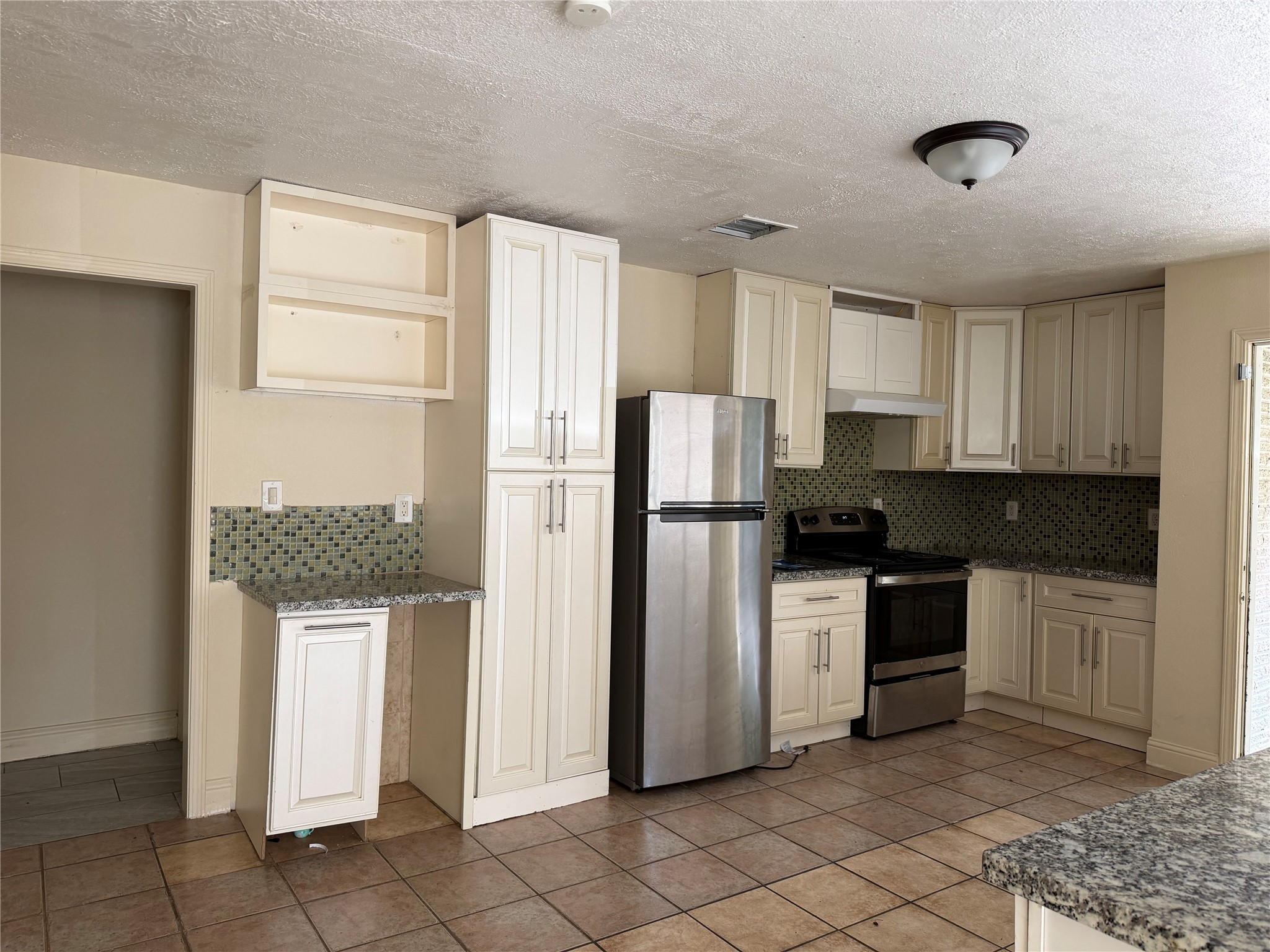 535 Brandon Road Conroe, TX 77302 - Photo 8 of 10 a kitchen with stainless steel appliances granite countertop a refrigerator sink and cabinets