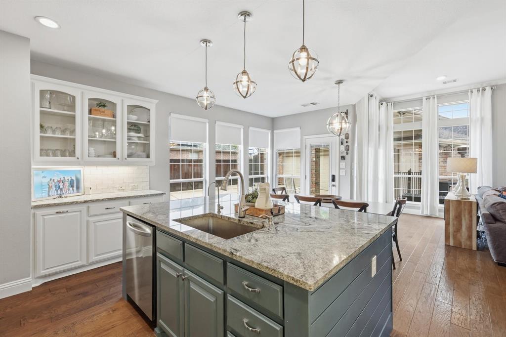 216 Durango Drive Trophy Club, TX 76262 - Photo 11 of 40 This open-concept kitchen features a spacious island with a granite countertop, a stainless steel sink, and stylish pendant lighting