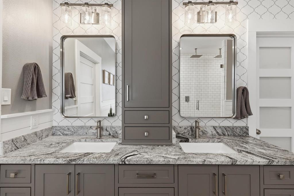 216 Durango Drive Trophy Club, TX 76262 - Photo 19 of 40 Bathroom featuring a dual vanity with undermount sinks, stone countertops, and gray cabinetry