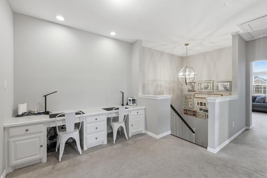 216 Durango Drive Trophy Club, TX 76262 - Photo 22 of 40 This property features a versatile loft space with recessed lighting and carpeting, offering a built-in desk area with cabinetry