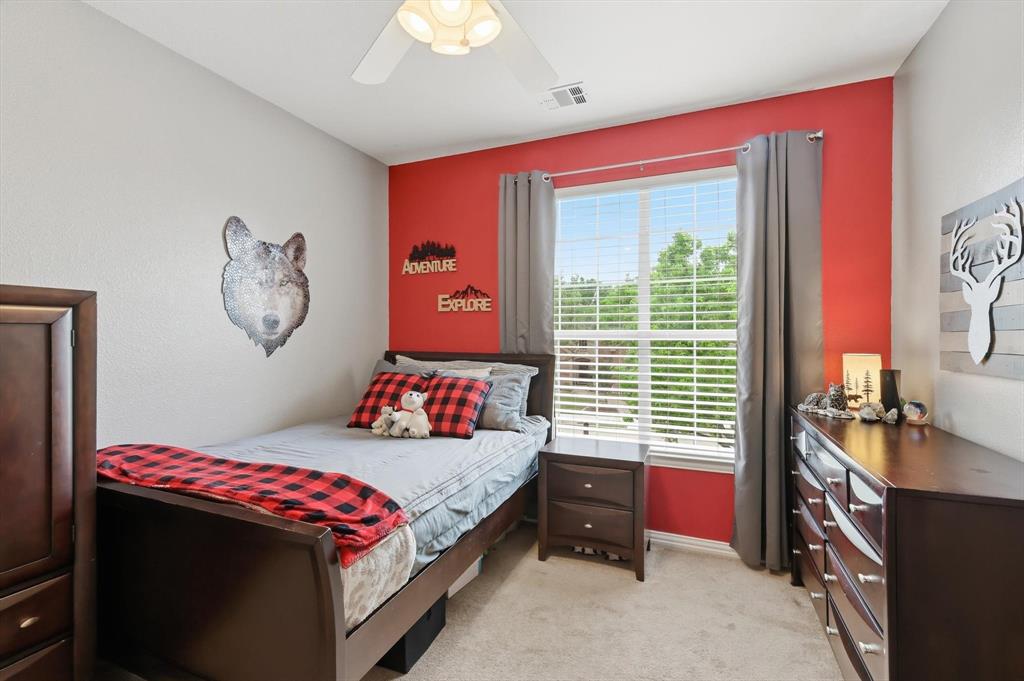 216 Durango Drive Trophy Club, TX 76262 - Photo 27 of 40 Bedroom with neutral walls and a vibrant accent wall