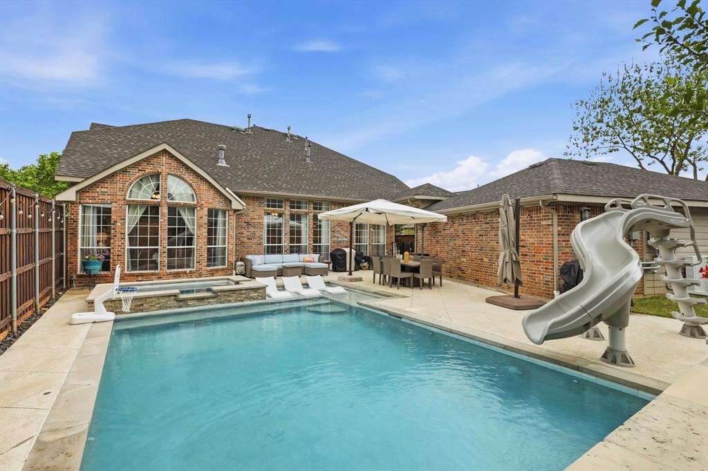 216 Durango Drive Trophy Club, TX 76262 - Photo 31 of 40 The property features a swimming pool with a slide, a hot tub, and a patio area