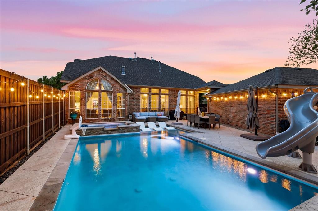 216 Durango Drive Trophy Club, TX 76262 - Photo 32 of 40 The property features a private swimming pool with an integrated spa, a paved patio, and a dedicated pool slide