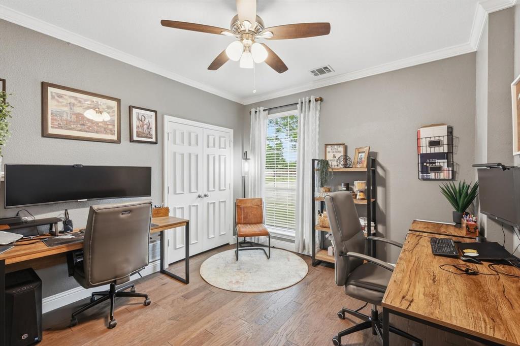 216 Durango Drive Trophy Club, TX 76262 - Photo 5 of 40 This versatile room features hardwood flooring, a ceiling fan, and crown molding