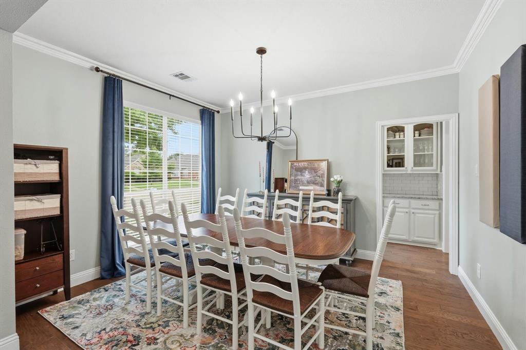 216 Durango Drive Trophy Club, TX 76262 - Photo 7 of 40 This dining area features hardwood floors, a large window with blinds, and crown molding