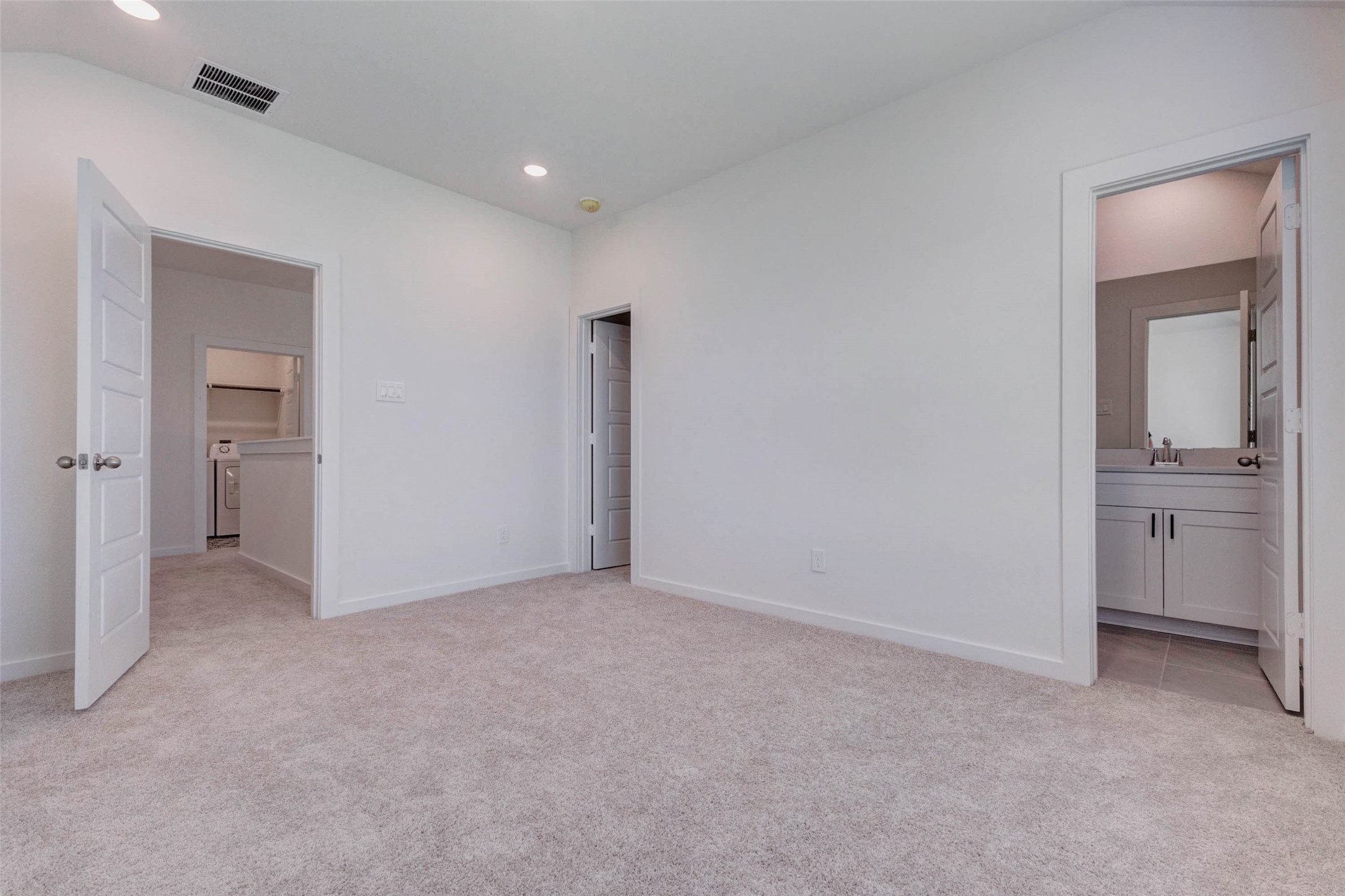 1206 Hemet Court Rosharon, TX 77583 - Photo 18 of 21 Secondary bedroom with soft carpet, recessed lighting, neutral walls, and direct access to a private or nearby bath area. Multiple doorways provide convenient flow to the hall, closet, and bathroom, making this room a flexible and comfortable space for guests, family members, or a private upstairs retreat.