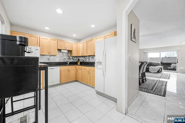 a kitchen with stainless steel appliances granite countertop a refrigerator sink and cabinets