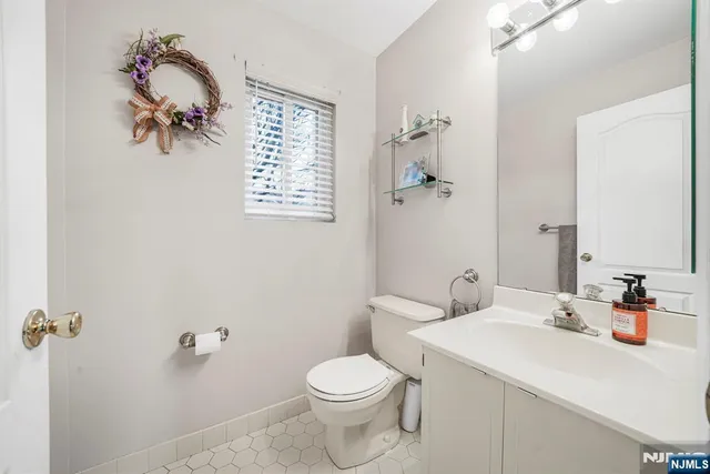 a bathroom with a sink a toilet and shower curtain