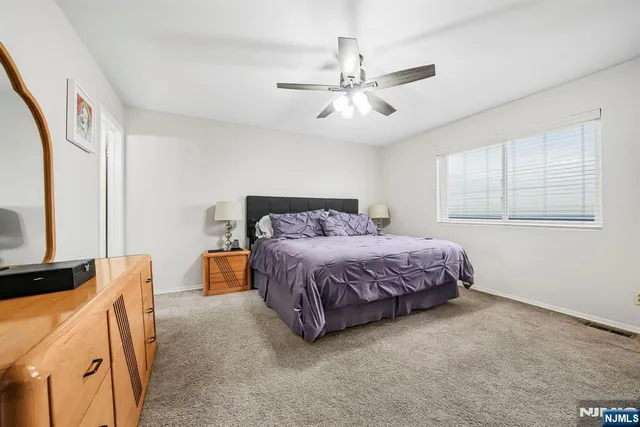 a bedroom with a bed dresser and a window