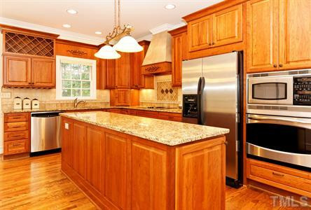 10813 Cahill Road Raleigh, NC 27614 - Photo 9 of 25 The beautiful custom cherry cabinetry is a great enhancement to the renovated kitchen! Kitchen