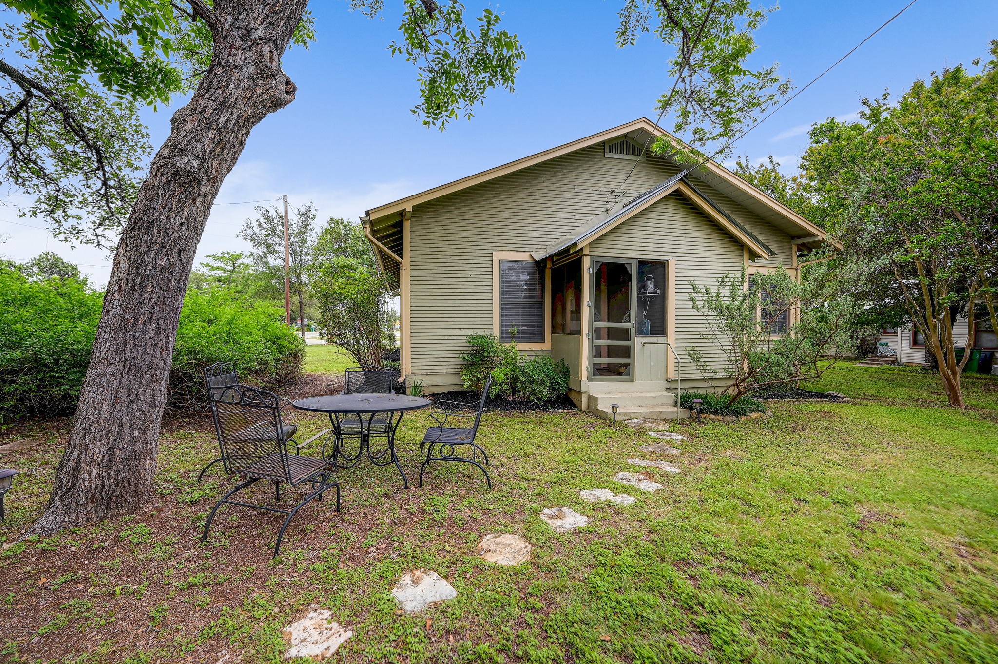719 Elm Street Blanco, TX 78606 - Photo 22 of 25 Single-story residence featuring a screened porch entry and light green siding