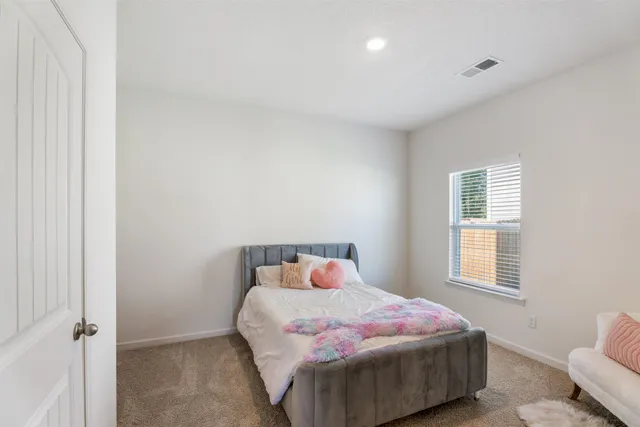 a living room with lots of baby furniture and a bed