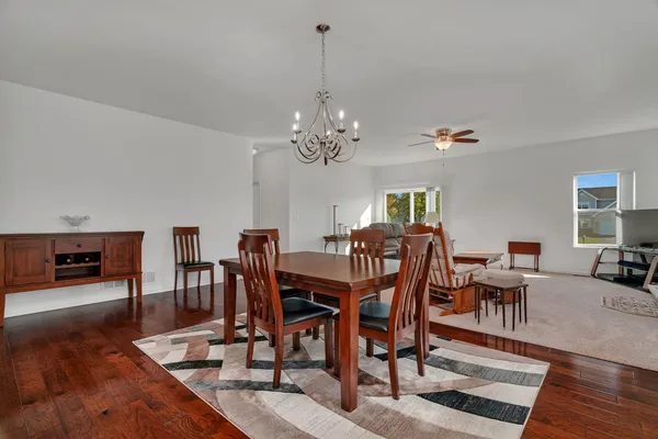 a view of a dining room with furniture wooden floor and chandelier