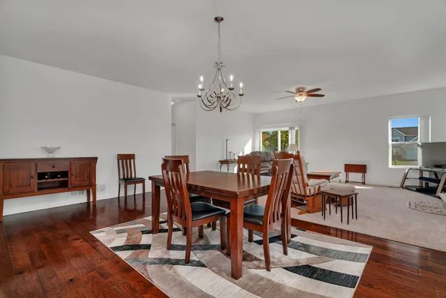 a view of a dining room with furniture wooden floor and chandelier