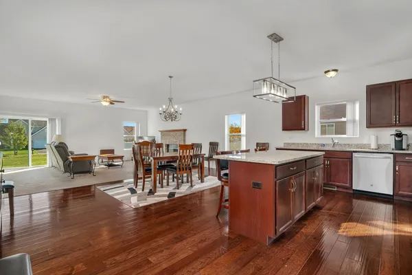 a large kitchen with lots of counter space a sink appliances and dining table