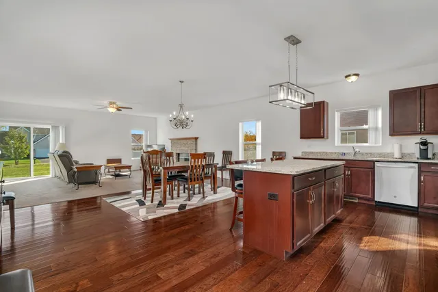 a large kitchen with lots of counter space a sink appliances and dining table
