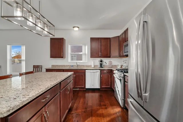 a kitchen with a sink stove and refrigerator