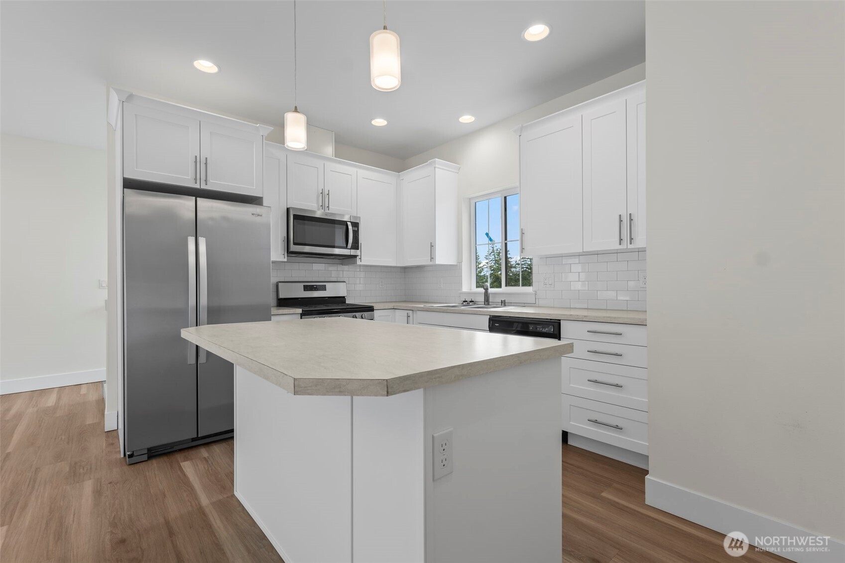 19013 Highway 3, Unit B Allyn, WA 98524 - Photo 4 of 22 a kitchen with a sink a microwave a refrigerator and cabinets