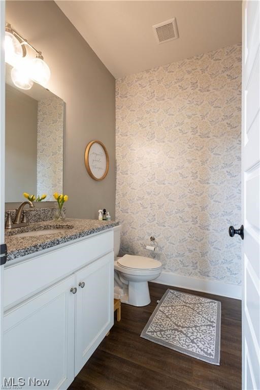 8151 Stone Road Medina, OH 44256 - Photo 4 of 11 Bathroom featuring oversized vanity, toilet, and hardwood / wood-style flooring