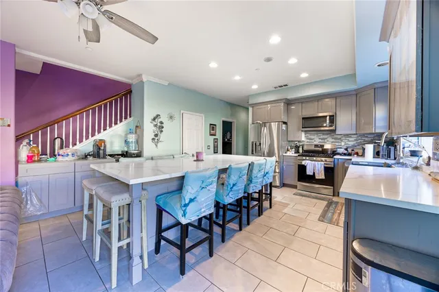 a kitchen with granite countertop lots of wooden cabinets a sink and a stainless steel appliances