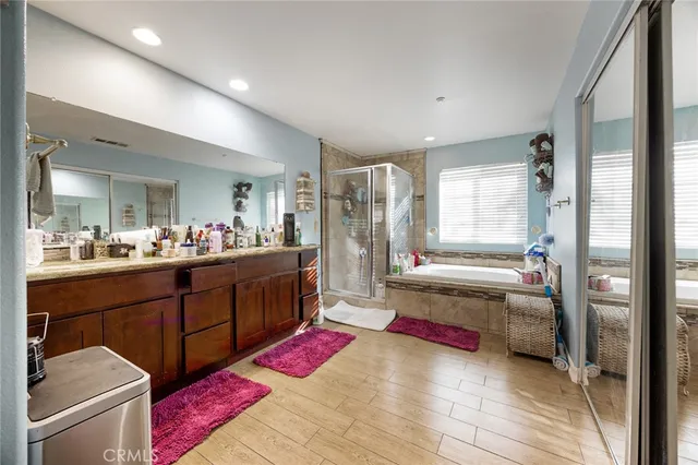 a kitchen with stainless steel appliances kitchen island granite countertop a refrigerator and a sink