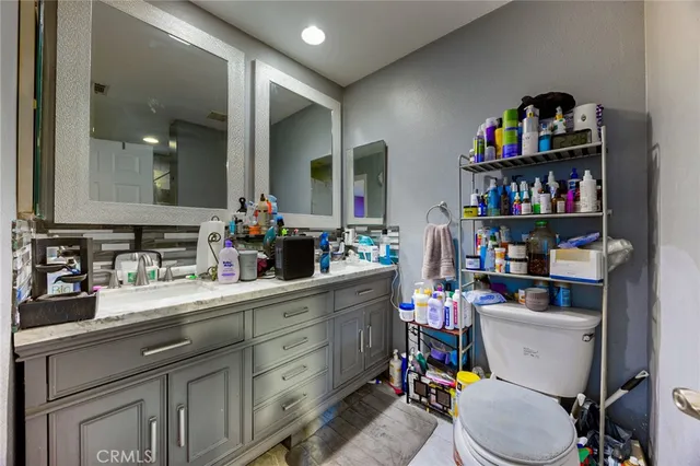 a bathroom with a sink a toilet and a mirror