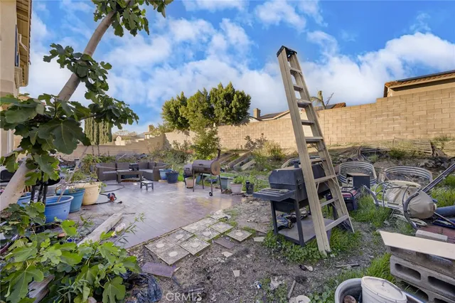 a view of a chairs and table in a backyard