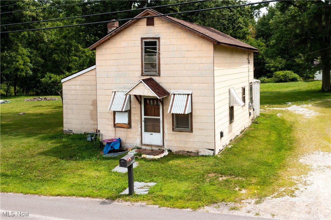 6283 Lafayette Road Medina, OH 44256 - Photo 2 of 8 View of front facade featuring a front yard and a chimney