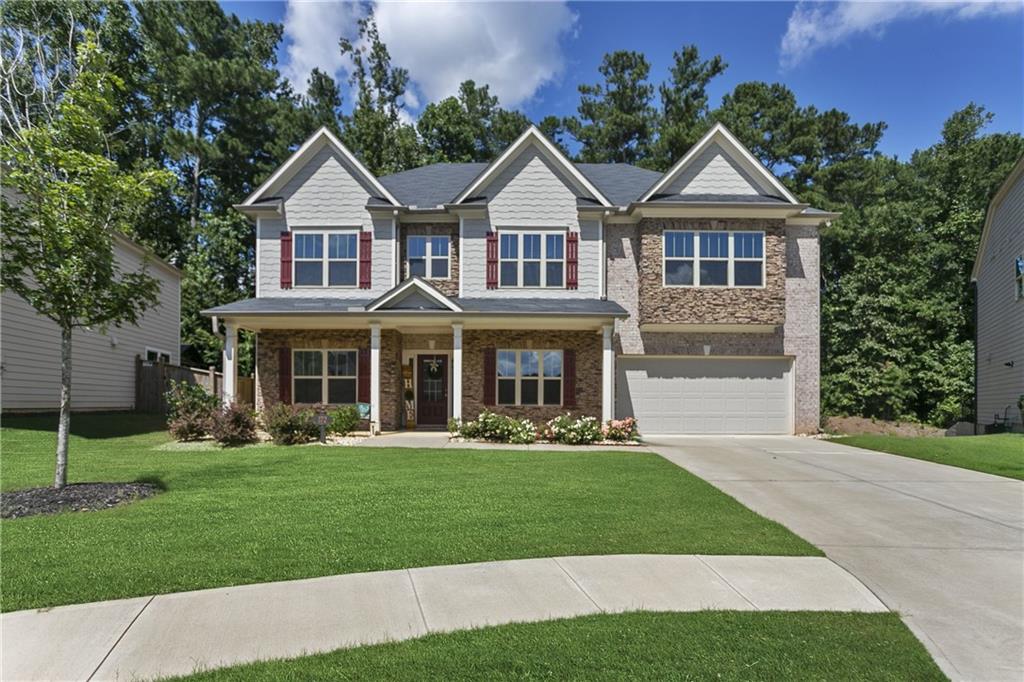 a front view of a house with a yard