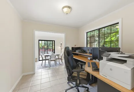 a view of a workspace with furniture and a window