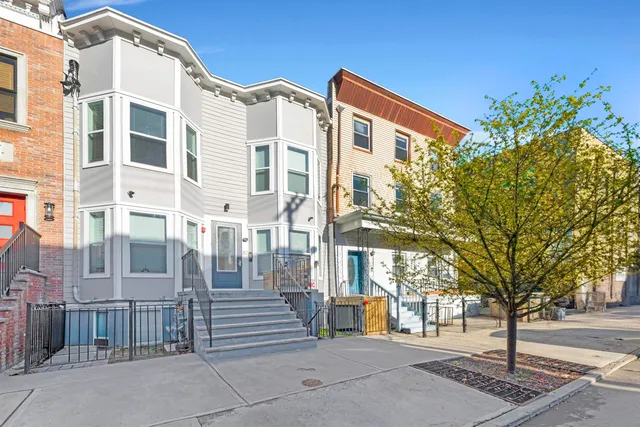 a front view of a building with a garden