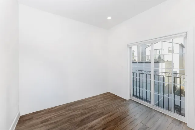a view of wooden floor and windows in a room