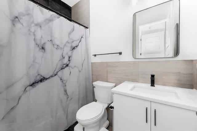 a bathroom with a sink toilet and shower