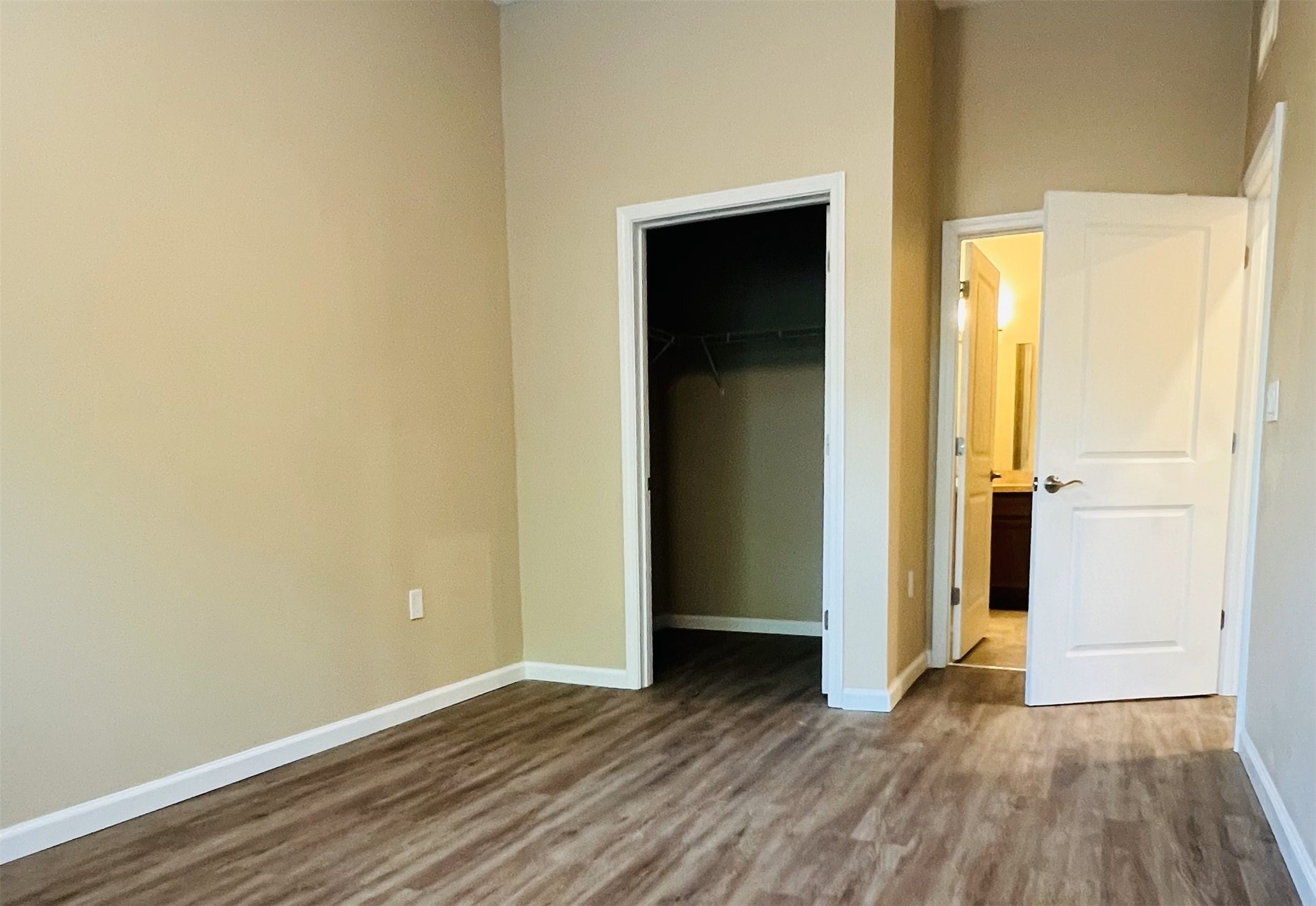 2131 Jackson Bluff Road Tallahassee, FL 32304 - Photo 3 of 9 an empty room with wooden floor and closet