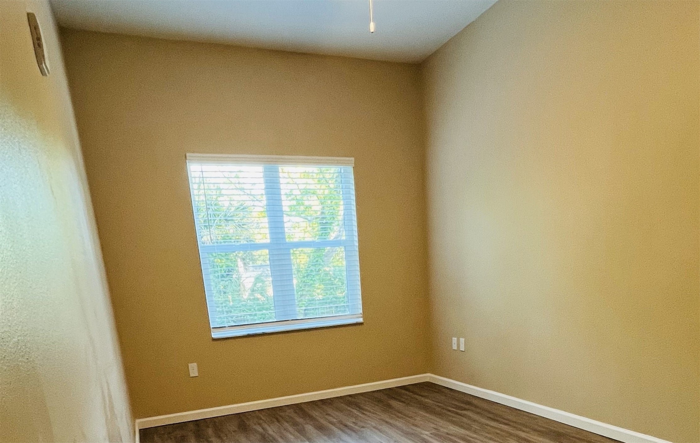 2131 Jackson Bluff Road Tallahassee, FL 32304 - Photo 6 of 9 an empty room with wooden floor and windows