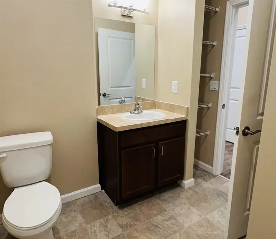 a bathroom with a toilet a sink and a mirror