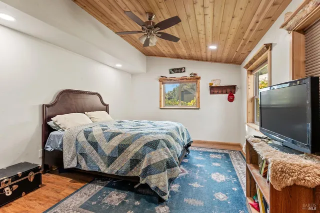 a bedroom with a bed and a flat screen tv
