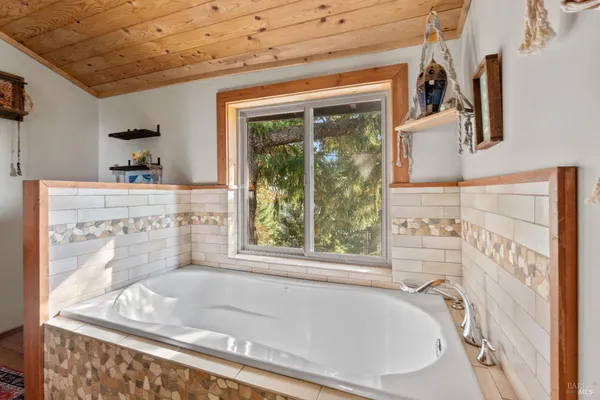 a bath tub sitting next to a window