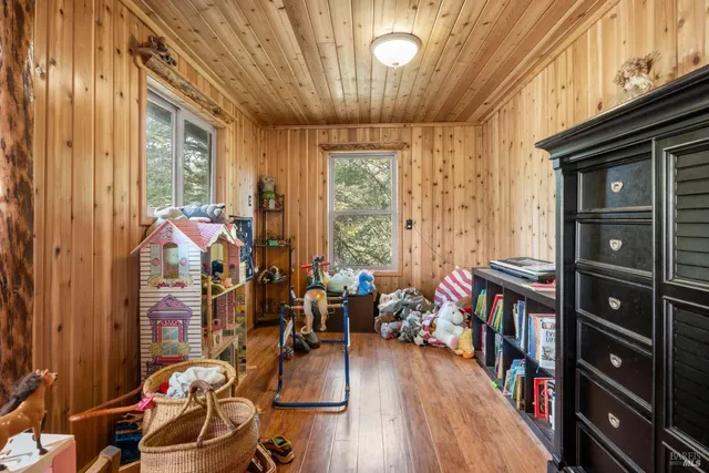 a very nice looking room with many windows and furniture