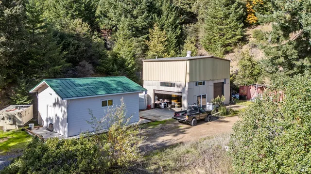 a view of backyard with seating space and trees