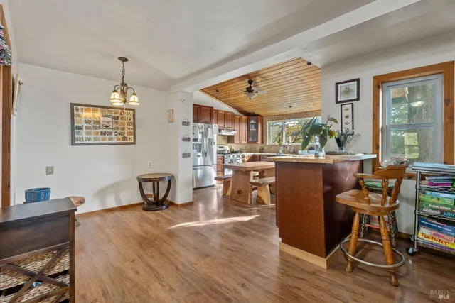 a dining room with furniture window and wooden floor