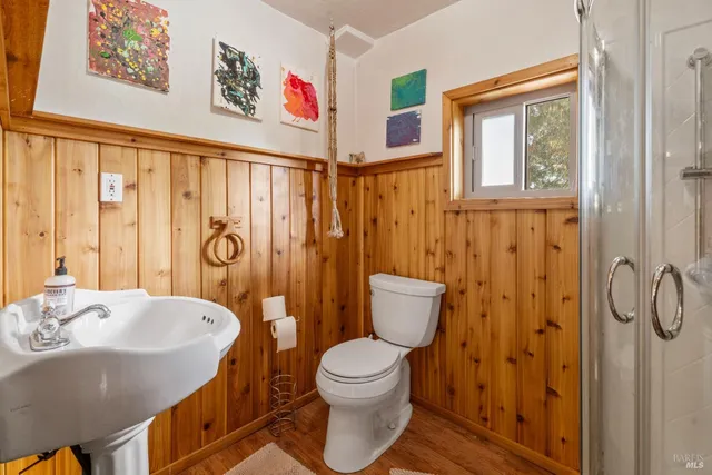 a bathroom with a sink a toilet and shower curtain
