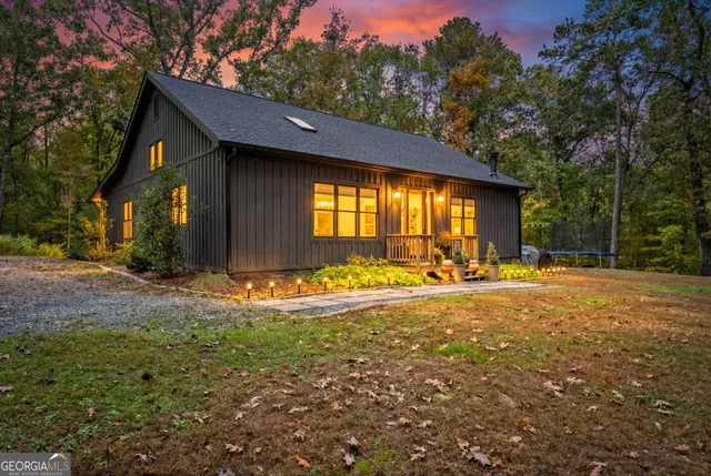 a view of house with yard and outdoor seating